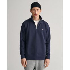 Bluza z pół zamkiem błyskawicznym Gant Shield. Niebieskie bluzy męskie GANT, xl, z aplikacjami, z bawełny, bez kaptura. Za 361.50 zł.