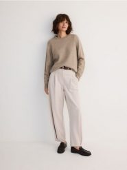 Spodnie z zakładkami z modalem - beżowy. Brązowe spodnie materiałowe damskie Reserved, l, bez wzorów, z dzianiny. W wyprzedaży za 79.99 zł.