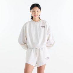 Bluza damska New Balance WT62X7T4LIT – biała. Białe bluzy damskie New Balance, m, z aplikacjami, z bawełny, bez kaptura. Za 269.99 zł.