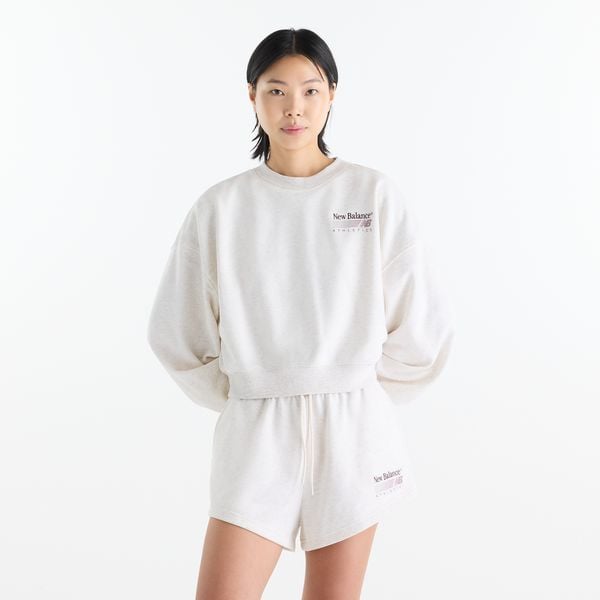 Bluza damska New Balance WT62X7T4LIT – biała. Białe bluzy damskie New Balance, m, z aplikacjami, z bawełny, bez kaptura. Za 269.99 zł.