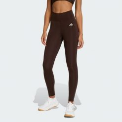 Długie legginsy Optimé Essentials Stash Pocket. Brązowe legginsy damskie Adidas, bez wzorów, z podwyższonym stanem, długie. Za 230.00 zł.