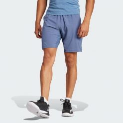 Szorty Tennis Ergo. Niebieskie krótkie spodenki sportowe męskie Adidas, s, bez wzorów, z elastanu, do biegania. Za 233.15 zł.