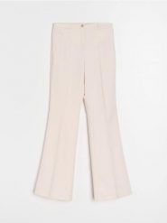 Eleganckie spodnie flare - kremowy. Białe spodnie materiałowe damskie Sinsay, l, bez wzorów. Za 49.99 zł.