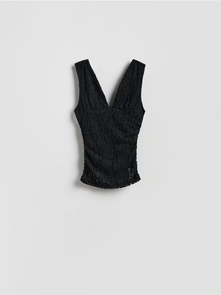 Kreszowana bluzka - czarny. Czarne bluzki damskie Reserved, l, bez wzorów, z dzianiny, bez kołnierzyka, bez ramiączek. W wyprzedaży za 32.99 zł.