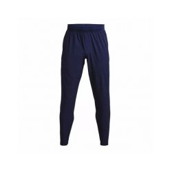 Spodnie dresowe Under Armour UA UNSTOPPABLE TAPERED PANTS. Niebieskie spodnie sportowe męskie Under Armour, s, bez wzorów, z dresówki, na fitness i siłownię. Za 407.25 zł.