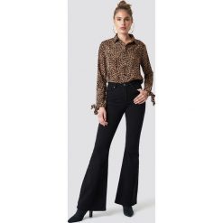Trendyol Spodnie dzwony z wysokim stanem - Black. Czarne spodnie materiałowe damskie Trendyol, z jeansu. Za 121.95 zł.