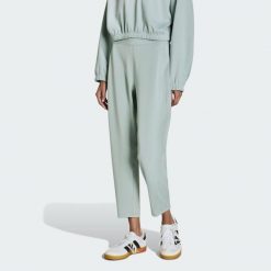 Spodnie All Me Yoga Essentials. Zielone spodnie materiałowe damskie Adidas, uniwersalny, bez wzorów, z materiału. Za 219.00 zł.