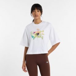 Koszulka damska New Balance WT61371RWT – biała. Białe t-shirty damskie New Balance, m, z aplikacjami, z materiału, bez kołnierzyka. Za 169.99 zł.