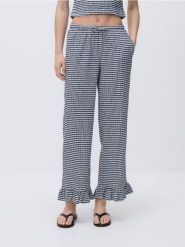 Spodnie z falbanką - granatowy. Niebieskie spodnie materiałowe damskie Reserved, l, bez wzorów, z dzianiny. Za 89.99 zł.