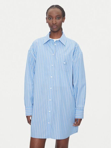 Tommy Jeans Sukienka koszulowa DW0DW21122 Niebieski Relaxed Fit. Niebieskie sukienki damskie Tommy Jeans, xxs, bez wzorów, z bawełny, bez kołnierzyka, bez ramiączek, koszulowe. Za 289.99 zł.