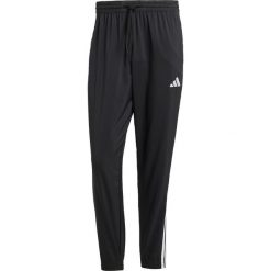 Tkane spodnie dresowe adidas Essentials 3-Stripes. Czarne spodnie sportowe męskie Adidas, m, bez wzorów, z dresówki. Za 234.75 zł.