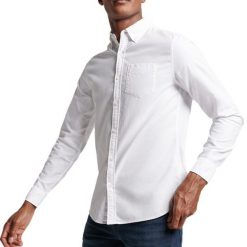Koszula z długim rękawem z bawełny organicznej Superdry Oxford. Białe koszule męskie Superdry., xl, bez wzorów, z bawełny, casualowe, bez kołnierzyka, bez ramiączek. Za 270.00 zł.
