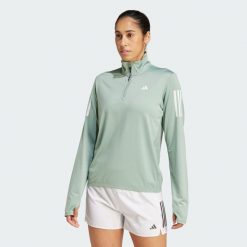 Kurtka Own the Run Half-Zip. Zielone bluzy sportowe damskie Adidas, m, bez wzorów, z materiału, bez kaptura, do biegania. Za 207.75 zł.