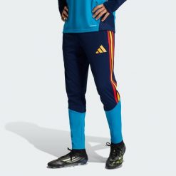 Spodnie Spain 26 Tiro Training. Niebieskie spodnie sportowe męskie Adidas, bez wzorów, z dresówki, do piłki nożnej. Za 279.00 zł.