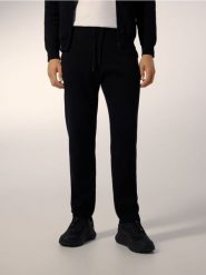 Dzianinowe spodnie jogger - czarny. Czarne spodnie materiałowe męskie Reserved, l, bez wzorów, z bawełny. Za 219.99 zł.