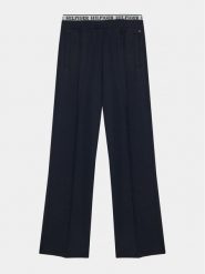 Tommy Hilfiger Spodnie materiałowe Monotype KG0KG07747 D Granatowy Regular Fit. Niebieskie spodnie materiałowe dla dziewczynek Tommy Hilfiger, bez wzorów, z materiału. Za 219.99 zł.
