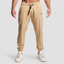 Spodnie męskie fitness jogger beżowe ARC. Brązowe spodnie sportowe męskie GYMBEAM, m, bez wzorów, z elastanu, na fitness i siłownię. Za 127.90 zł.