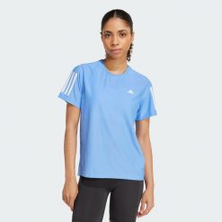 Koszulka Own The Run. Niebieskie koszulki sportowe damskie Adidas, s, bez wzorów, z materiału, bez kołnierzyka, bez ramiączek, do biegania. Za 149.00 zł.