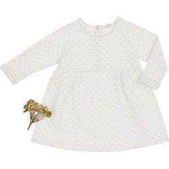 Sukienka w kolorze kremowym. Białe sukienki niemowlęce Benetton Kids, bez wzorów, bez ramiączek. W wyprzedaży za 52.95 zł.