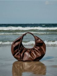 Torebka hobo z zawieszką - brązowy. Brązowe torebki do ręki damskie Reserved, bez wzorów, ze skóry, bez dodatków. W wyprzedaży za 55.99 zł.
