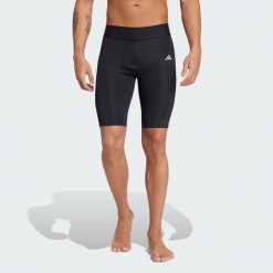 Legginsy TECHFIT Short. Czarne legginsy sportowe męskie Adidas, bez wzorów, z materiału, do piłki nożnej, techfit (adidas). Za 90.99 zł.