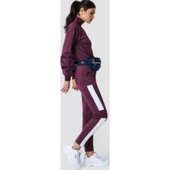 NA-KD Spodnie sportowe - Purple. Fioletowe spodnie sportowe damskie NA-KD. W wyprzedaży za 66.98 zł.