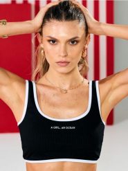 Góra od bikini typu top z kontrastową lamówką i napisem - czarny. Czarne topy damskie Sinsay, l, bez wzorów, bez kołnierzyka, bez ramiączek. Za 29.99 zł.