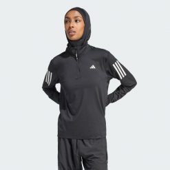 Kurtka Own the Run Half-Zip. Czarne kurtki sportowe damskie Adidas, s, bez wzorów, z materiału, bez kaptura, do biegania. W wyprzedaży za 201.65 zł.