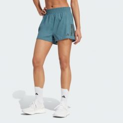 Szorty Own the Run. Niebieskie szorty sportowe damskie Adidas, bez wzorów, sportowe, do biegania. Za 179.00 zł.