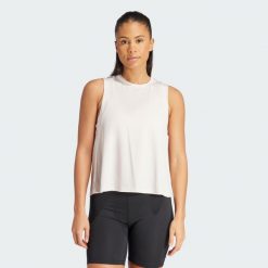 Koszulka Studio Tank. Fioletowe koszulki sportowe damskie Adidas, uniwersalny, bez wzorów, z materiału, bez kołnierzyka, bez ramiączek, na fitness i siłownię. Za 148.05 zł.