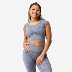 Koszulka fitness damska Domyos crop top seamless. Szare koszulki sportowe damskie DOMYOS, s, bez wzorów, z materiału, sportowe, bez kołnierzyka. Za 89.99 zł.