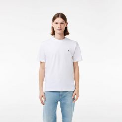 Koszulki Lacoste Model Th7318 Tee-shirt Kolor Biały. Białe koszulki sportowe męskie Lacoste, bez wzorów, z tkaniny, bez kołnierzyka, bez ramiączek, tenisowe. Za 257.05 zł.