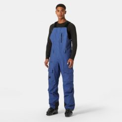 Spodnie narciarskie z szelkami i kieszenią cargo Helly Hansen Sogn. Niebieskie spodnie snowboardowe męskie Helly Hansen, m, bez wzorów, narciarskie. Za 1,037.00 zł.