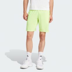 Szorty Tennis Ergo. Żółte koszulki sportowe męskie Adidas, bez wzorów, z materiału, bez kołnierzyka, bez ramiączek, tenisowe. Za 234.05 zł.