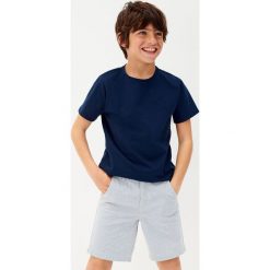 Mango Kids - Szorty dziecięce Evan 122-164 cm. Niebieskie szorty dla chłopców Mango Kids, bez wzorów, z bawełny, casualowe. W wyprzedaży za 39.90 zł.