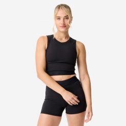 Koszulka fitness damska Domyos crop top. Czarne koszulki sportowe damskie DOMYOS, bez wzorów, z elastanu, na fitness i siłownię. Za 69.99 zł.