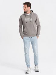 Męskie spodnie jeansowe JOGGERY z przetarciami - jasnoniebieskie V1 OM-PADJ-0150 - XXL. Niebieskie spodnie materiałowe męskie Ombre Clothing, l, bez wzorów, z bawełny. W wyprzedaży za 69.99 zł.