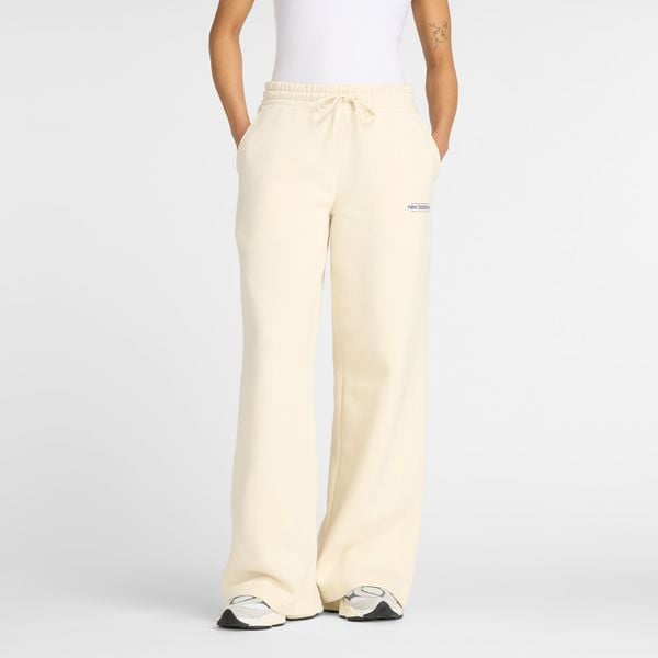 Spodnie damskie New Balance WP53903LIN – beżowe. Brązowe spodnie materiałowe damskie New Balance, s, z aplikacjami, z bawełny, z podwyższonym stanem. Za 279.99 zł.