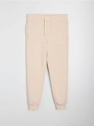 Spodnie jogger slim fit - beżowy. Brązowe spodnie sportowe męskie Sinsay, l, bez wzorów. Za 49.99 zł.