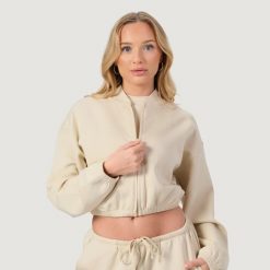 Bluza damska fitness z zamkiem bez kaptura migdałowa NEO. Brązowe bluzy damskie GYMBEAM, l, bez wzorów, z bawełny, bez kaptura, na fitness i siłownię. Za 119.90 zł.