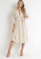 Beżowa Sukienka Rheniolea. Brązowe sukienki damskie Born2be, m, bez wzorów, eleganckie, bez kołnierzyka, bez ramiączek, midi, kopertowe. Za 79.99 zł.