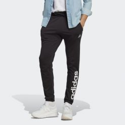 Spodnie dresowe męskie adidas Essentials Single Jersey Tapered Elasticized Cuff. Niebieskie buty sportowe męskie Adidas, z dresówki, bez zapięcia, na fitness i siłownię. Za 159.00 zł.