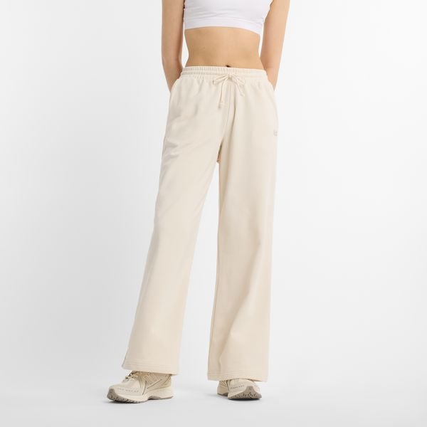 Spodnie damskie New Balance WP51503LIN – beżowe. Brązowe spodnie materiałowe damskie New Balance, l, z aplikacjami, z bawełny. Za 359.99 zł.