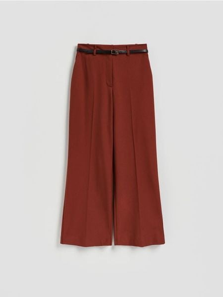 Spodnie z paskiem - miedziany. Brązowe spodnie materiałowe damskie Reserved, l, bez wzorów, z tkaniny. Za 159.99 zł.