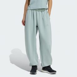 Spodnie Soft Lux Loose. Zielone spodnie materiałowe damskie Adidas, l, bez wzorów, z bawełny. Za 374.50 zł.
