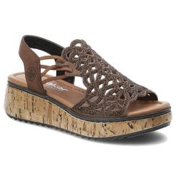 Sandały damskie Rieker, cholewka ze skóry ekologicznej ażurowa konstrukcja ozdobne zdobienia z drobnymi nitami, brązowe, V1765-24. Brązowe klapki damskie Rieker, z aplikacjami, ze skóry ekologicznej, bez obcasa, na koturnie. Za 349.00 zł.