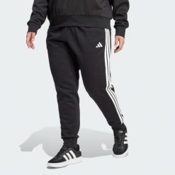 Spodnie Essentials 3-Stripes Fleece Slim (Plus Size). Czarne obuwie sportowe damskie Adidas, plus size, bez wzorów, z polaru. Za 219.00 zł.