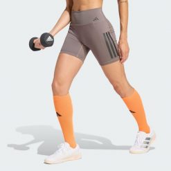 Krótkie legginsy Optime Workout 3-Stripes. Brązowe legginsy damskie Adidas, bez wzorów, z lycry. Za 199.00 zł.