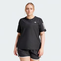 Koszulka Own The Run (Plus Size). Czarne koszulki sportowe damskie Adidas, m, bez wzorów, z materiału, sportowe, bez kołnierzyka. Za 159.00 zł.