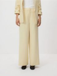 Spodnie z szerokimi nogawkami - jasnożółty. Żółte spodnie materiałowe damskie Reserved, l, bez wzorów, z tkaniny. Za 119.99 zł.